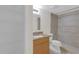 Bathroom featuring a shower and vanity with granite countertop and storage shelves at 2820 Somerset Park Dr # 101, Tampa, FL 33613