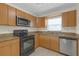 Well-equipped kitchen with stainless steel appliances, tile floors, and granite countertops at 2820 Somerset Park Dr # 101, Tampa, FL 33613
