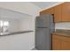 A refrigerator and a pass-through window enhances the kitchen's functionality and layout at 2820 Somerset Park Dr # 101, Tampa, FL 33613
