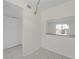 Bright and airy living room with tile flooring and a pass-through window to the kitchen at 2820 Somerset Park Dr # 101, Tampa, FL 33613