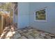 Private patio with stone flooring, access door, and a view of the building's exterior at 2820 Somerset Park Dr # 101, Tampa, FL 33613