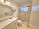 Clean bathroom featuring a walk-in shower with glass doors, a vanity with ample counter space, and neutral color palette at 2850 59Th S St # 310, Gulfport, FL 33707