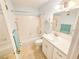 Well-maintained bathroom featuring a shower-tub combo, white tile, and a vanity with plenty of counter space at 2850 59Th S St # 310, Gulfport, FL 33707