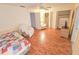 Bright bedroom with wood-look floors, ceiling fan and closet; features a full bed and comfortable seating at 2850 59Th S St # 310, Gulfport, FL 33707