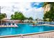 Expansive community pool with ample seating, lush greenery, and views of the bay on a sunny day at 2850 59Th S St # 310, Gulfport, FL 33707