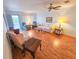 Inviting living room featuring wood-look flooring, neutral paint, ceiling fan, and balcony access at 2850 59Th S St # 310, Gulfport, FL 33707