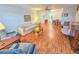 Cozy living room featuring wood-look flooring, neutral paint, ceiling fan, and dining room access at 2850 59Th S St # 310, Gulfport, FL 33707