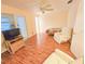 Open living room with wood-look floors and neutral color palette; features ceiling fan and doorway access to other rooms at 2850 59Th S St # 310, Gulfport, FL 33707