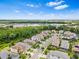 Wide aerial view showcasing a residential community with lush greenery and scenic surroundings at 30410 Ceasar Park Dr, Wesley Chapel, FL 33543