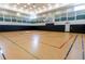 Community indoor basketball court with hardwood flooring, basketball hoop, and soundproofing at 30410 Ceasar Park Dr, Wesley Chapel, FL 33543