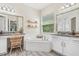 Bright bathroom featuring a garden tub, double vanity, and a separate water closet with wood-look tile floors at 30410 Ceasar Park Dr, Wesley Chapel, FL 33543
