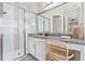 Bathroom featuring a glass-enclosed shower, a vanity with granite counters, and wood-look tile floors at 30410 Ceasar Park Dr, Wesley Chapel, FL 33543