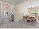 Open concept view of entry hall and formal dining room featuring a wooden dining table with seating for eight at 30410 Ceasar Park Dr, Wesley Chapel, FL 33543