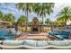 Community fireplace with outdoor seating and palm trees, ideal for relaxation and entertainment at 30410 Ceasar Park Dr, Wesley Chapel, FL 33543