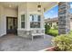 Charming front porch with stone accents, a cozy bench, and stylish decor elements at 30410 Ceasar Park Dr, Wesley Chapel, FL 33543