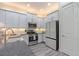 Stylish kitchen with gray cabinets, subway tile backsplash, stainless steel appliances and wood-look tile floors at 30410 Ceasar Park Dr, Wesley Chapel, FL 33543