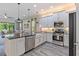 Modern kitchen with stainless steel appliances, white cabinetry, a kitchen island, and stylish pendant lighting at 30410 Ceasar Park Dr, Wesley Chapel, FL 33543