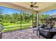 Spacious screened lanai with brick flooring and seating area at 30410 Ceasar Park Dr, Wesley Chapel, FL 33543