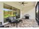 Relaxing covered lanai with seating and grill at 30410 Ceasar Park Dr, Wesley Chapel, FL 33543