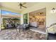 Covered lanai featuring tile flooring, seating, and grill at 30410 Ceasar Park Dr, Wesley Chapel, FL 33543
