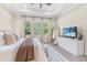 Cozy bedroom featuring a plush carpet, a large bed, lots of natural light, and a full-length mirror at 30410 Ceasar Park Dr, Wesley Chapel, FL 33543