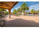 View from cabana across tiled pool patio of lounge chairs, lush palms and nearby water park at 30410 Ceasar Park Dr, Wesley Chapel, FL 33543