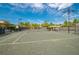 Community tennis courts with green surface, nets, and lighting fixtures under a sunny sky at 30410 Ceasar Park Dr, Wesley Chapel, FL 33543