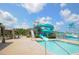 Community waterpark featuring water slides, lounge area, and shallow pool on a sunny day at 30410 Ceasar Park Dr, Wesley Chapel, FL 33543