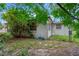 A portion of the backyard showing the edge of the home and some foliage at 3547 Odom Dr, New Port Richey, FL 34652