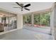 Enclosed bonus room featuring a ceiling fan, multiple windows, and access to the outdoors at 3547 Odom Dr, New Port Richey, FL 34652