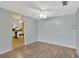 Dining room with wood-look flooring, ceiling fan and an adjacent kitchen at 3547 Odom Dr, New Port Richey, FL 34652