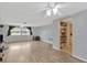 Open living room with wood-look flooring, windows and hallway to other rooms at 3547 Odom Dr, New Port Richey, FL 34652