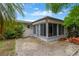 Enclosed patio with brick pavers and ample sunlight creates a cozy outdoor living space at 3547 Odom Dr, New Port Richey, FL 34652