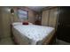 Cozy bedroom featuring a comfortable bed, closet and warm lighting at 37229 Lois Ave, Zephyrhills, FL 33542