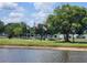 Landscaped grounds include flags, benches, statues, and a beautiful lake at 37229 Lois Ave, Zephyrhills, FL 33542