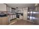 Functional kitchen featuring white cabinets, appliances, and a dining table at 37229 Lois Ave, Zephyrhills, FL 33542