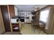Functional kitchen featuring white cabinets, appliances, and a dining table at 37229 Lois Ave, Zephyrhills, FL 33542
