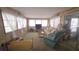 Bright living room with large windows, comfortable seating, and lots of natural light at 37229 Lois Ave, Zephyrhills, FL 33542