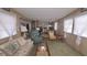 Cozy living room with comfortable seating and direct access to the kitchen at 37229 Lois Ave, Zephyrhills, FL 33542
