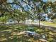 Outdoor recreation area featuring a gazebo, stone table with benches, and minigolf at 37229 Lois Ave, Zephyrhills, FL 33542