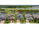 Aerial view of home showing landscaping, nearby pond, and community at 3972 Wisdom Trl, Land O Lakes, FL 34638