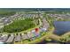 Beautiful aerial view of a neighborhood with mature trees and ponds at 3972 Wisdom Trl, Land O Lakes, FL 34638