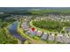 Stunning aerial view of a neighborhood with scenic pond at 3972 Wisdom Trl, Land O Lakes, FL 34638