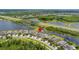 Aerial shot showing community layout near ponds, road, and natural areas at 3972 Wisdom Trl, Land O Lakes, FL 34638