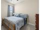Comfortable bedroom with natural light and blue accents at 3972 Wisdom Trl, Land O Lakes, FL 34638