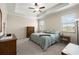 Spacious bedroom with tray ceiling, plush carpet and a large window at 3972 Wisdom Trl, Land O Lakes, FL 34638