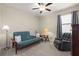 Neutral bedroom featuring a futon, a comfortable chair, carpet and a large window at 3972 Wisdom Trl, Land O Lakes, FL 34638