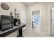 Hallway featuring a coffee bar with sleek appliances, granite countertop, and access to bathroom at 3972 Wisdom Trl, Land O Lakes, FL 34638
