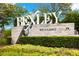 Elegant community entrance sign with lush landscaping and decorative planters at 3972 Wisdom Trl, Land O Lakes, FL 34638