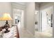 Inviting hallway with neutral tones, tile flooring, and elegant lighting that leads to an open-concept kitchen at 3972 Wisdom Trl, Land O Lakes, FL 34638